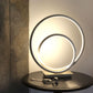 Lysende Loop bordlampe formet som to loops med integrert LED-lys laget i stål 3-stegs dimbar - Aneta belysning